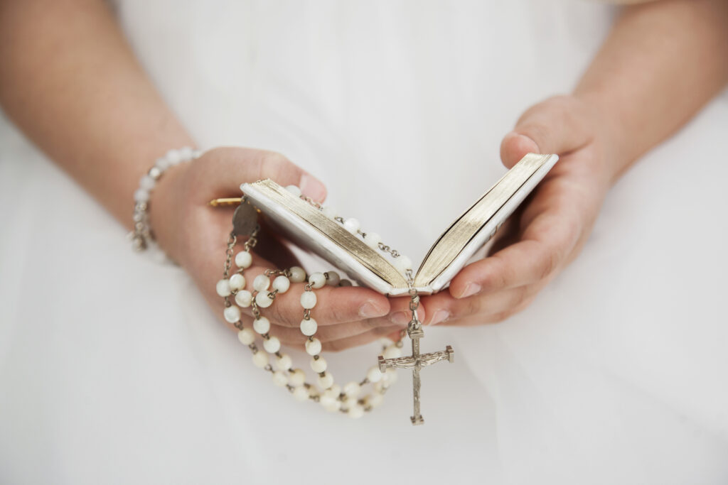 close up child hands holy communion 1